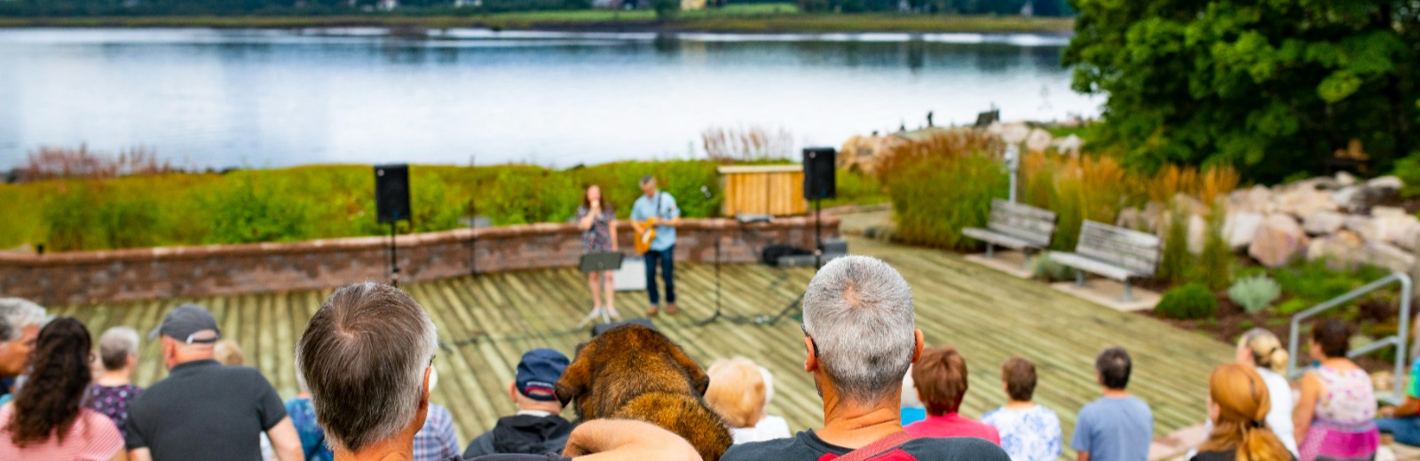 Residents watching musicians at an outside stage